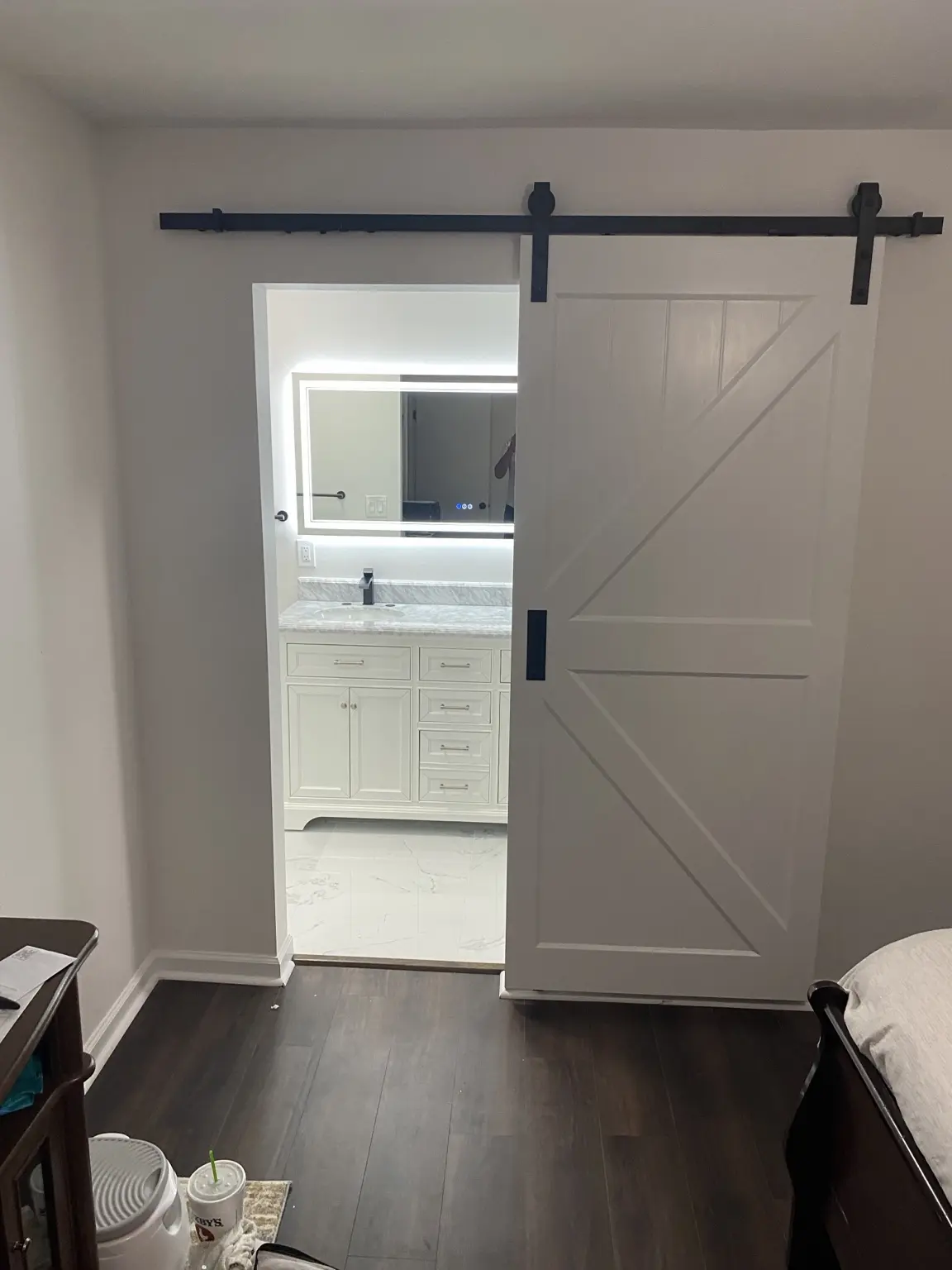 Sliding barn door opening to renovated bathroom