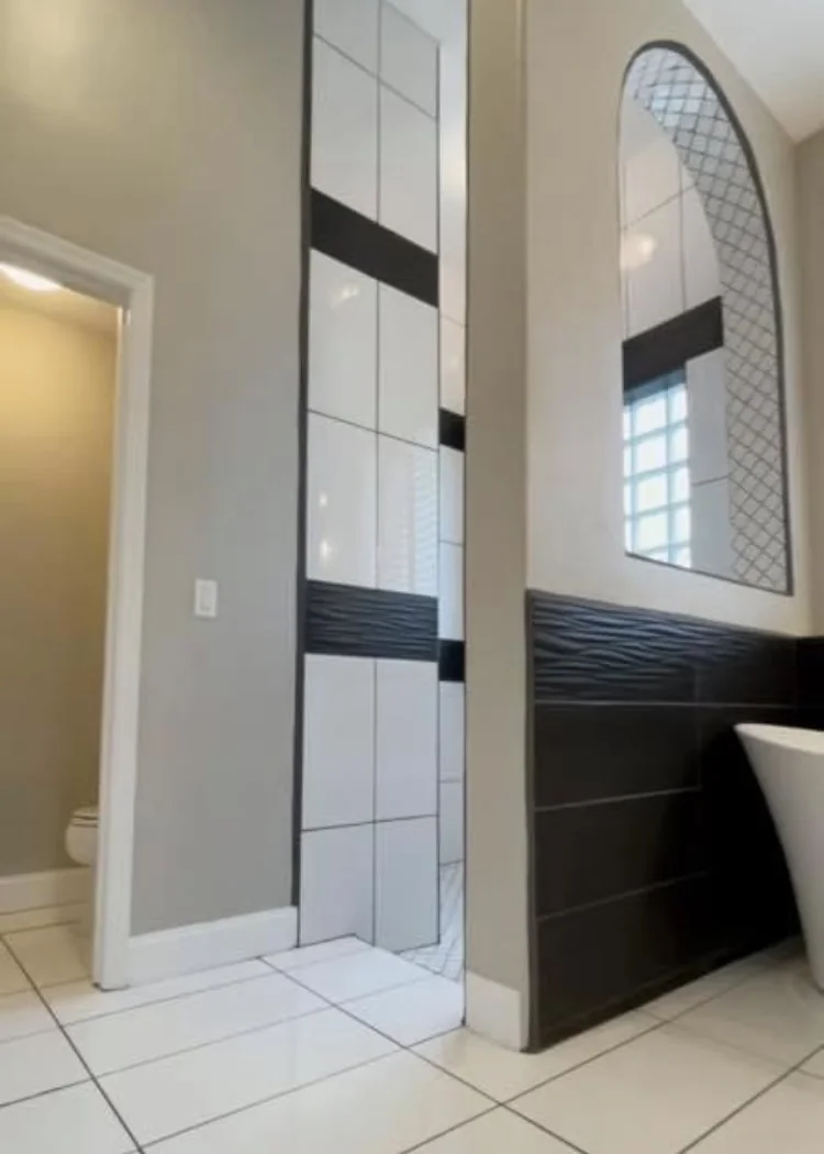 Bathroom entry with contrasting tile and glass-block window