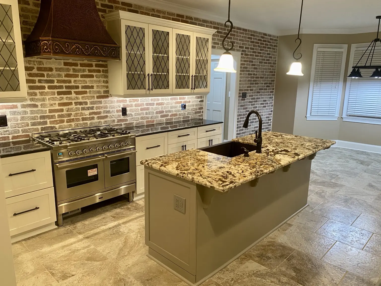 Custom kitchen with brick backsplash and island