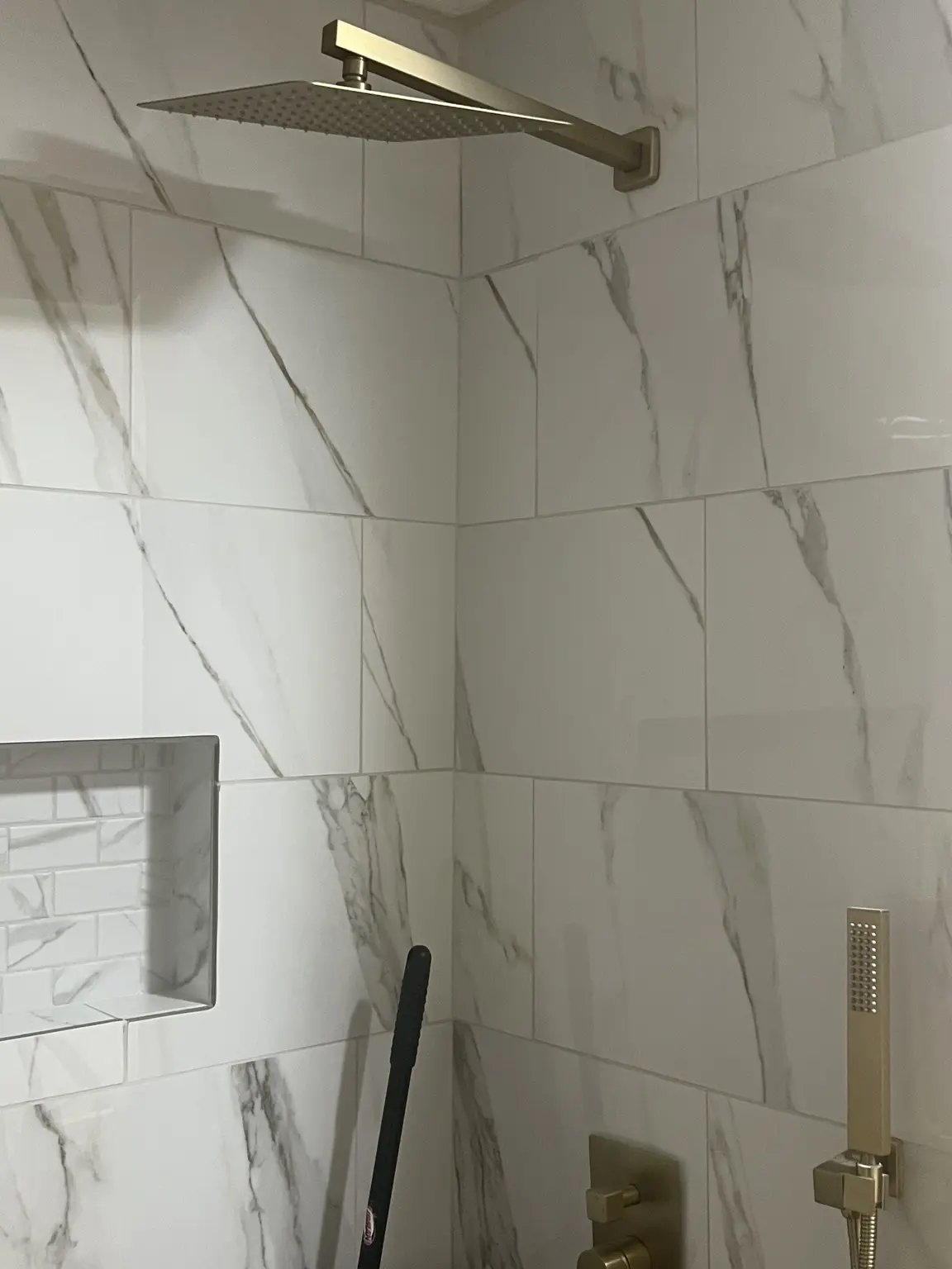 Large-format marble-look shower tile detail
