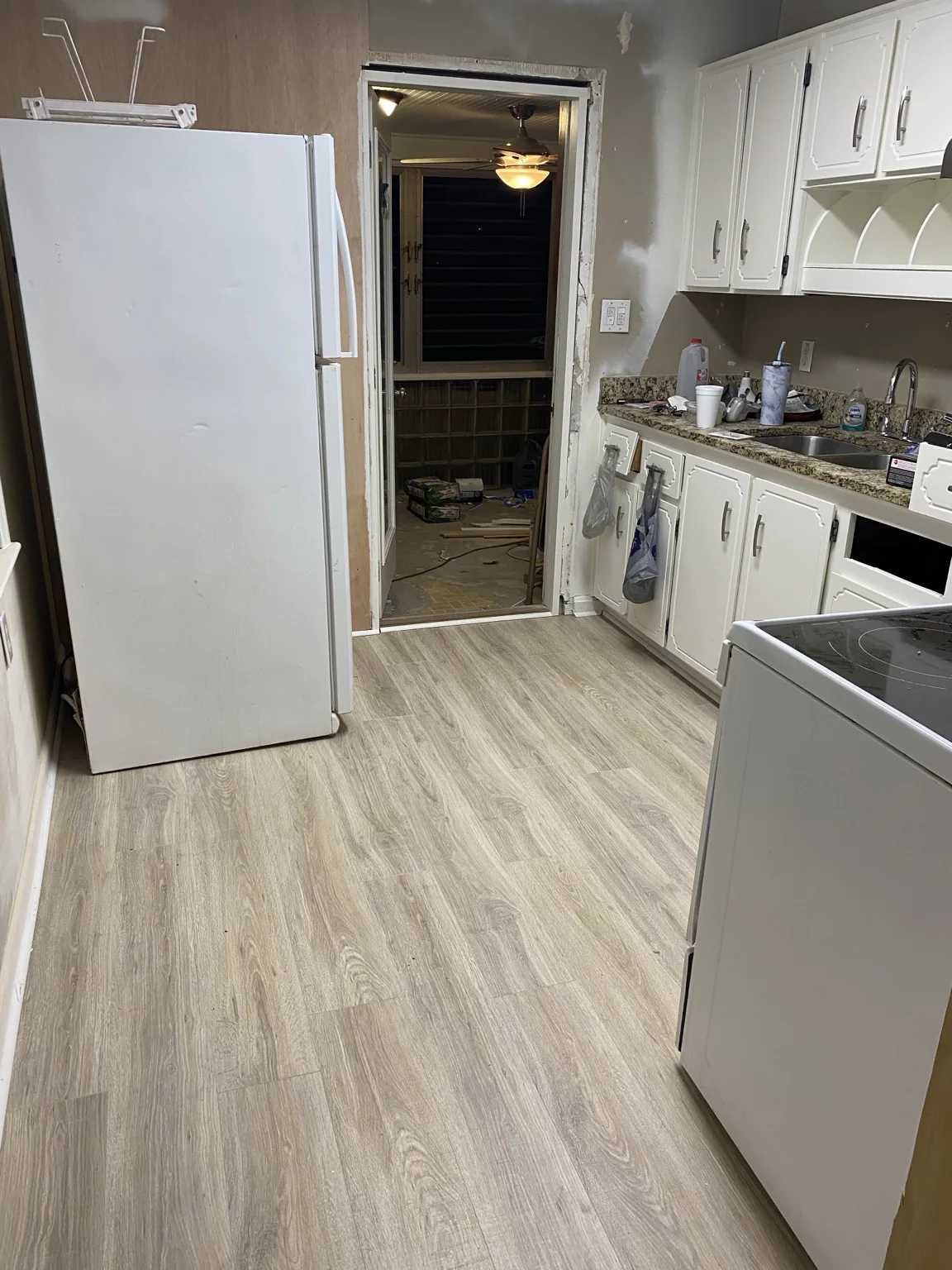 Wood-look plank flooring installed through a kitchen
